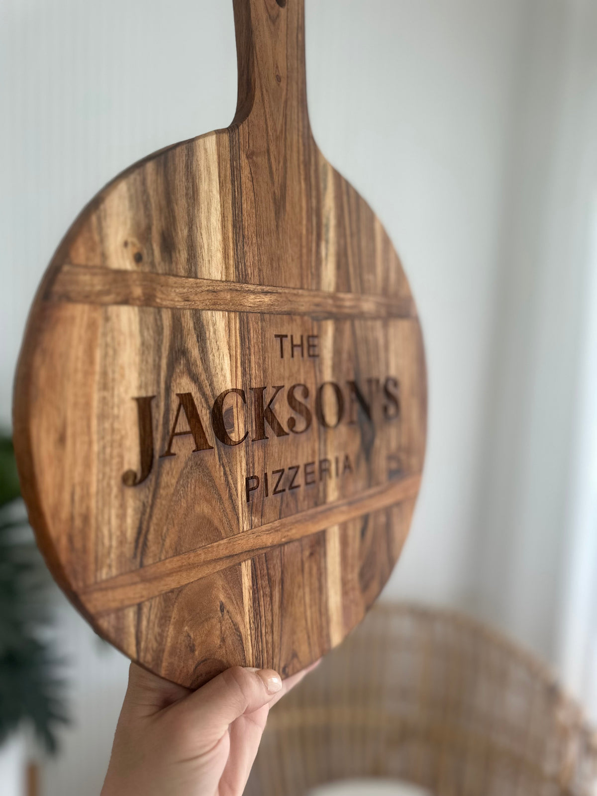 Acacia pizza board with Jackson name engraved on it