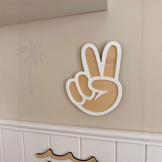 Peace sign in timber and white acrylic outline hanging on a surf theme bedroom