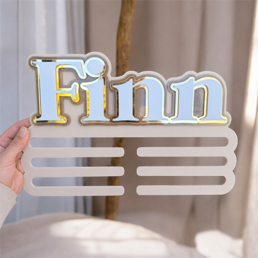 Medal Holder with personalised name 'Finn' for a child's bedroom in beige neutral colours