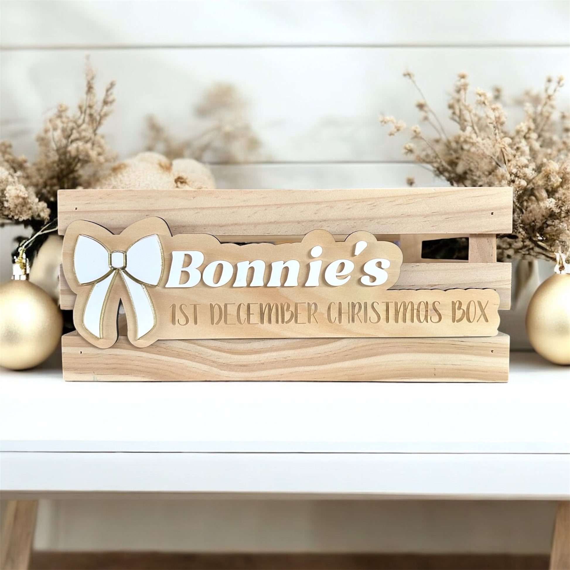 wooden crate with personalised name plaque with bow for christmas, that states 1st December or Christmas eve box