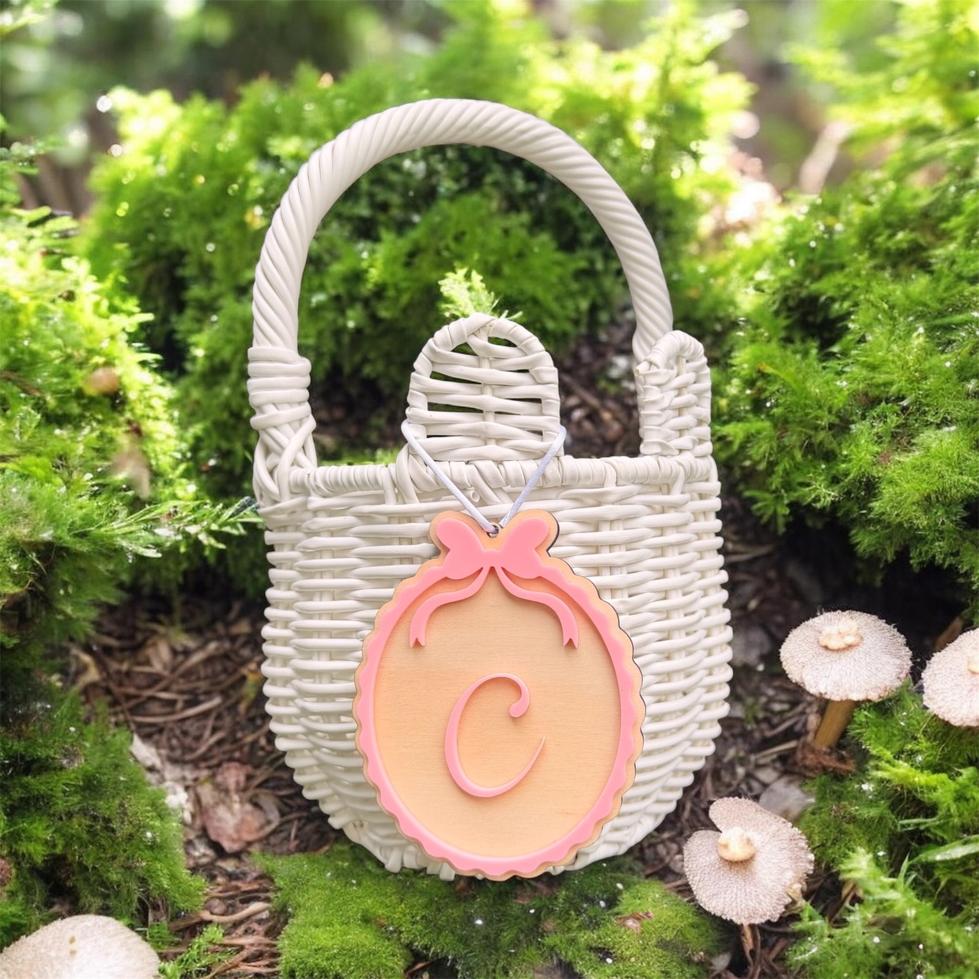 Custom Easter Basket name tag in Pink with C initial hanging on white wicker basket