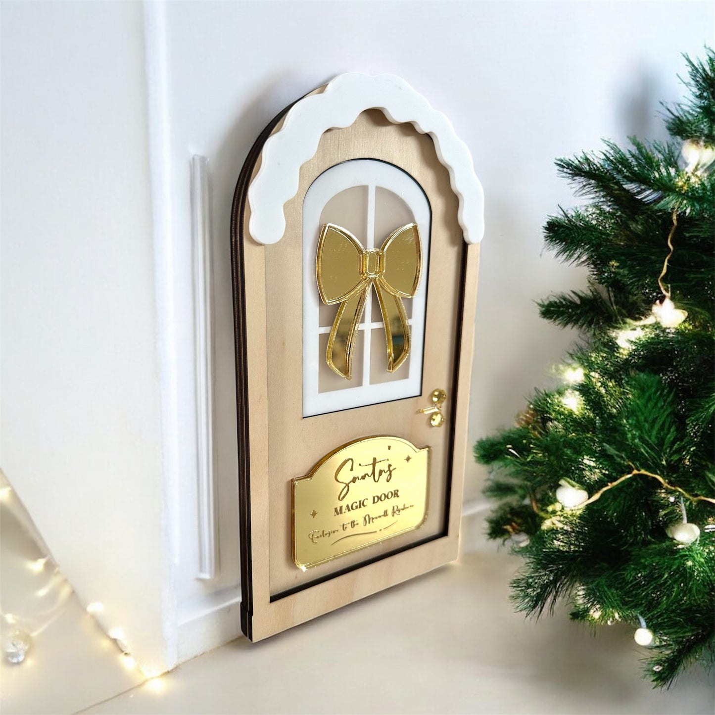 decorate magical santa door with gold bow for those you don't have a chimney